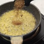Add dry coriander to garlic