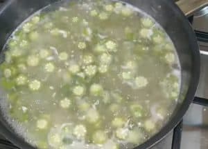 After 5 minutes, add 4 minced garlic cloves and mix them well with the okra