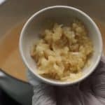cooking pot on the fire and add a teaspoon of chopped garlic to it