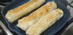 Turn the shawarma wrap on the other side and keep stirring until you reach the grainy roasting point.