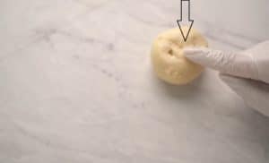 Apply the smooth side of the dough sticking to the surface