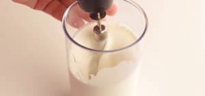 Put the whipping cream in a large cup and mix it with a mixer